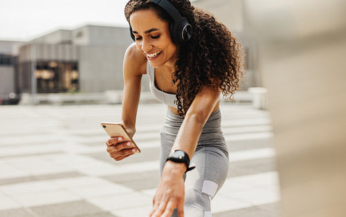 Woman using phone during workout