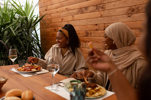 Cheerful female friends enjoying a wholesome meal in a restauran
