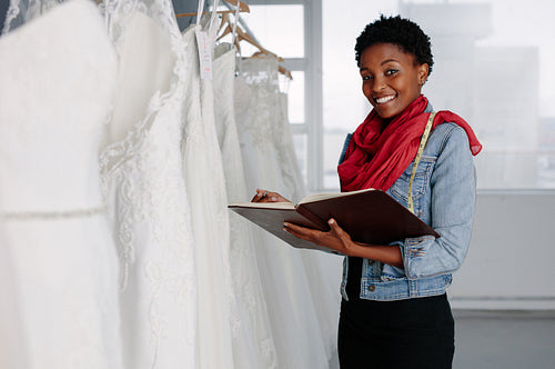 Female bridal wear designer working in boutique