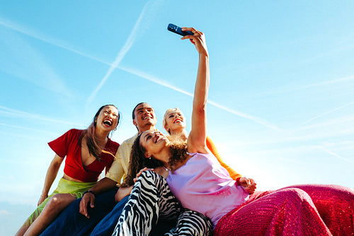 Friends taking a selfie outdoors during summer vacation