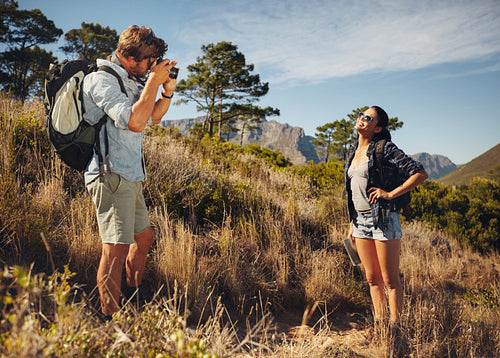 Tourist couple enjoying nature and taking photo