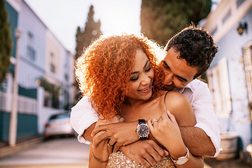 Young couple having fun in the street on a sunny day.
