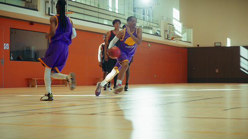 Basketball players in an indoor stadium