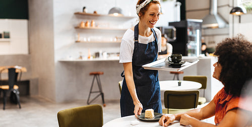 Restaurant waitress serving a customer her food