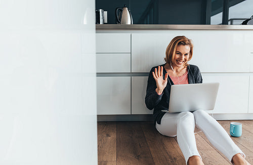 Woman video calling over laptop computer