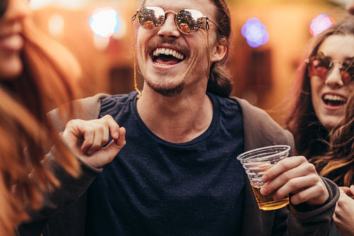 Man with friends dancing at music festival