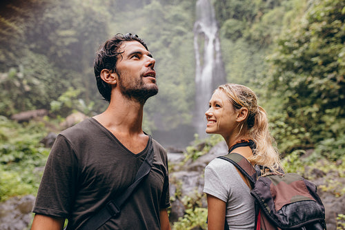 Young couple with backpack hiking in nature.