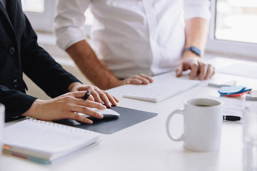 Two business associates working together at office desk
