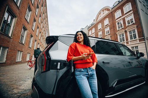 City charging with a car and smartphone keeps a woman on the move