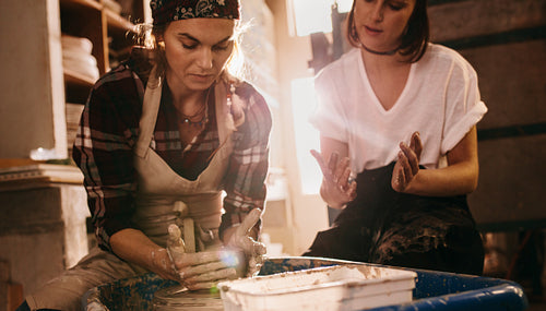 Female potter working on potters wheel