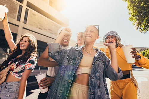 Happy friends dancing in the city