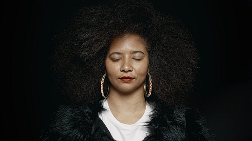 Afro woman with eyes closed