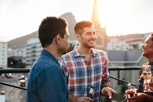 Happy young people having a rooftop party
