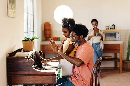 Father showing his daughter how he works from home