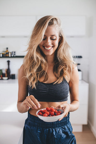 Smiling woman having healthy breakfast at home