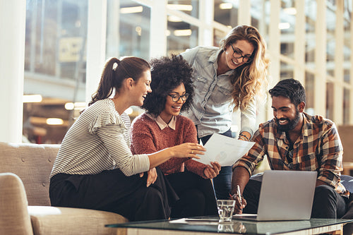 Team of coworkers looking at a business paper