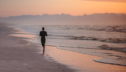 Runner training on the beach in morning