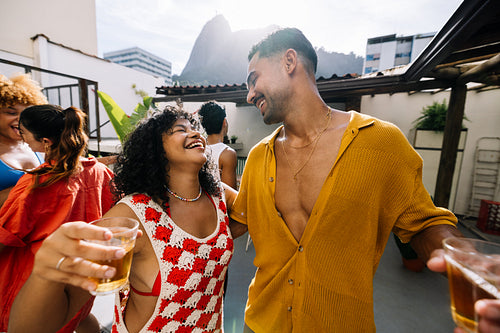 Friends enjoying a rooftop gathering in Rio de Janeiro on a sunny day