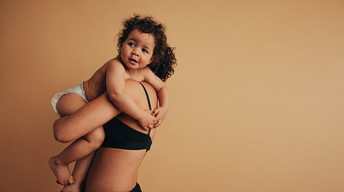 Cute infant in arms of mom