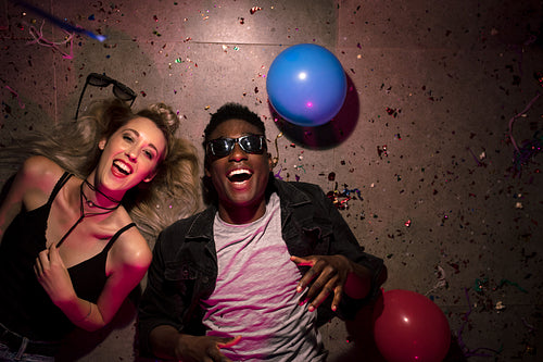 Couple lying on the floor at a house party