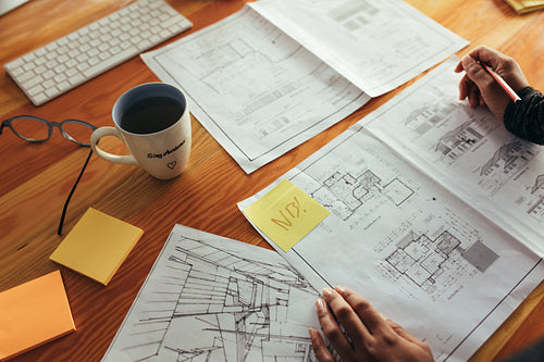 Woman architect working on floor plan of a building