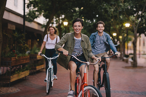 Young friends cycling in the city