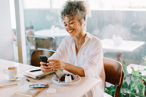 Businesswoman on video call in a cafe