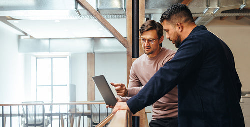 Business man discussing a tech project with his colleague in an office