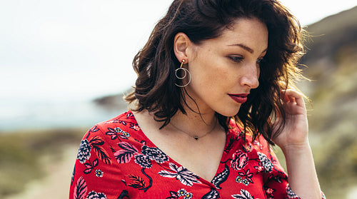 Beautiful woman standing outdoors looking down