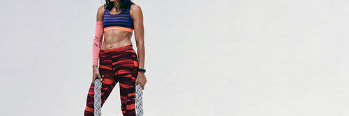 Athletic woman with battle ropes on white background