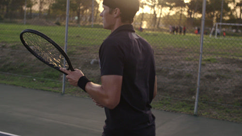 Tennis player practicing forehands from baseline