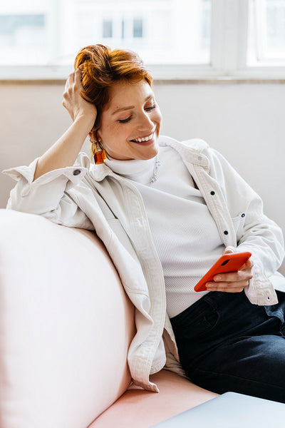 Woman relaxing in a co-working space with her phone