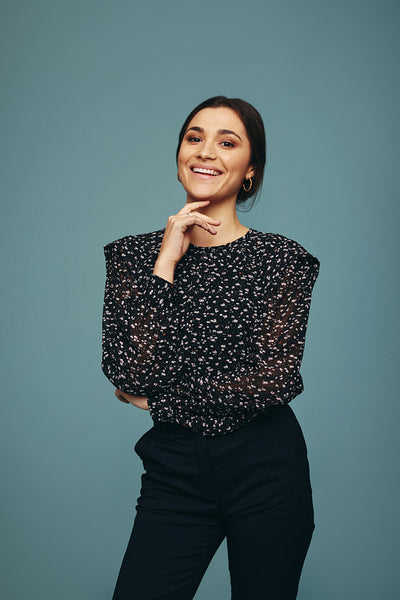 Happy young woman smiling cheerfully in a studio