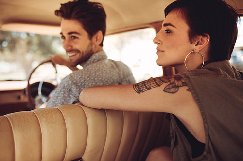Friends traveling by a car