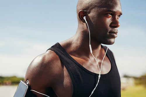 Fit young man wearing earphones