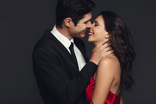 Smiling couple about to kiss each other