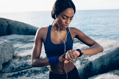 Runner checking fitness progress on her smartwatch
