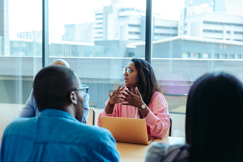 Businesswoman actively talking during a business meeting with colleagues