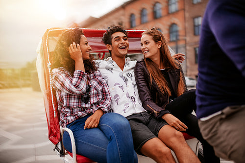 Friends having fun on tricycle ride