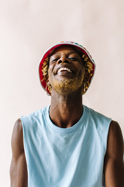 Cheerful gay man smiling in a studio