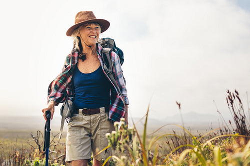 Cheerful senior woman enjoying her hiking trip