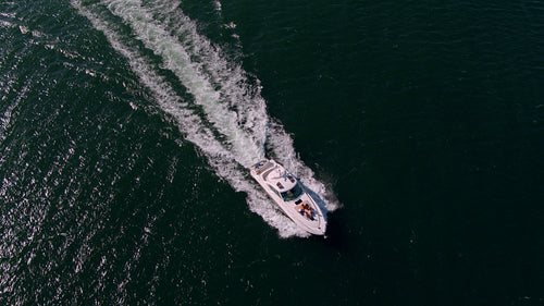 Yacht sailing in sea with young people on deck