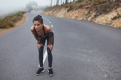 Fitness woman taking a break during the running workout