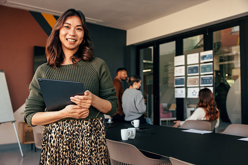 Happy busineswoman smiling at the camera in a boardroom