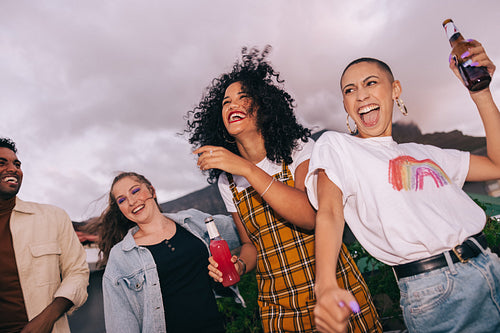 Cheerful friends partying on a rooftop