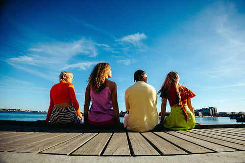 Young friends enjoy sunny day by the waterfront