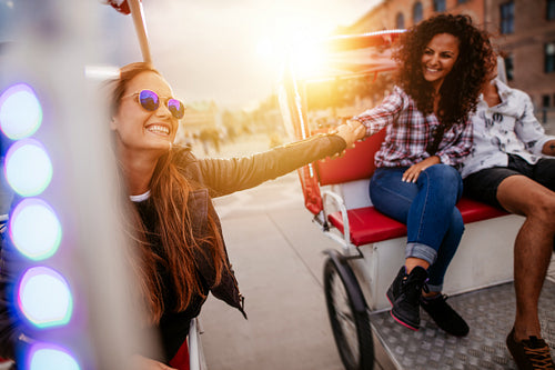 Best friends enjoying tricycle ride in the city