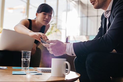 Young business people using mobile phone