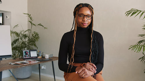 Happy graphic designer smiling at the camera in her office