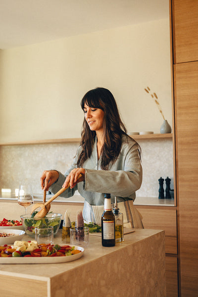 Woman preparing a fresh salad in a modern home kitchen